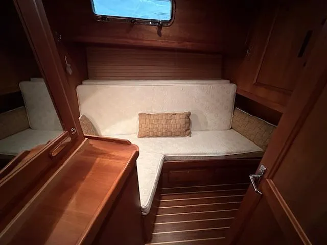 Slide: The Image of 2004 Sabre 42 Express Hardtop cabin interior with wooden finish and cushioned seating. - 48