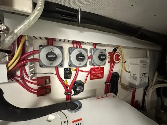 Slide: The Image of Electrical panel in 2004 Sabre 42 Express Hardtop boat, featuring multiple switches and wiring. - 52