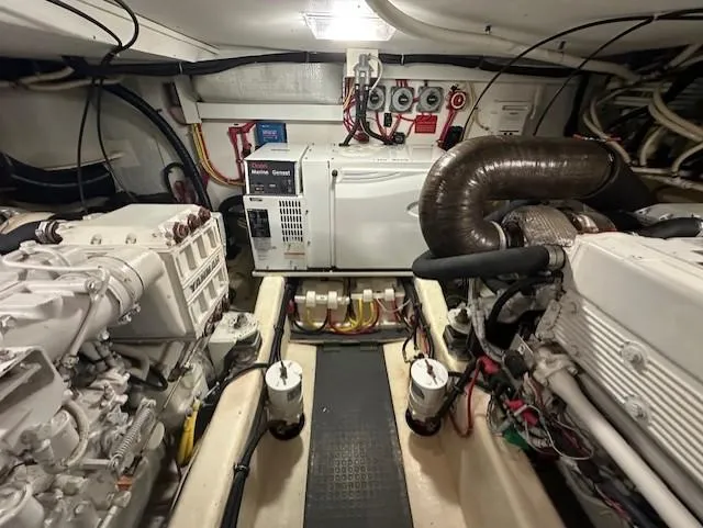 Slide: The Image of Engine room of 2004 Sabre 42 Express Hardtop with visible machinery and components. - 57