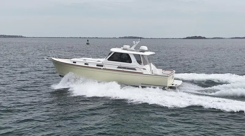 Slide: The Image of 2004 Sabre 42 Express Hardtop cruising on open water. - 6