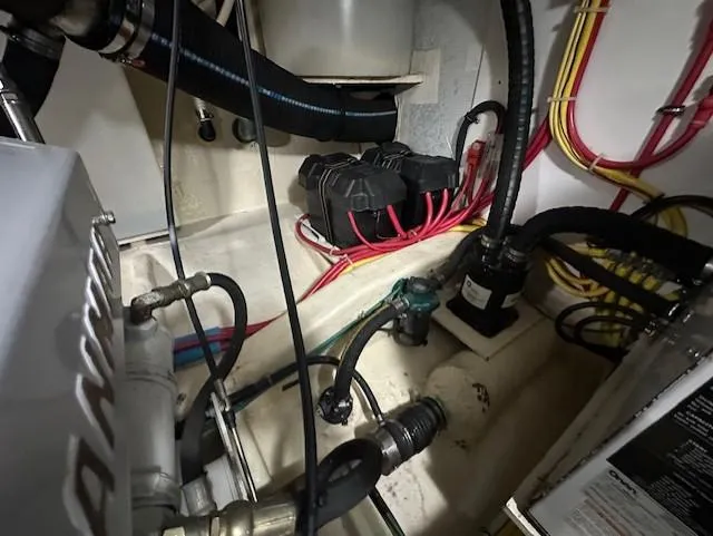 Slide: The Image of Engine compartment of a 2004 Sabre 42 Express Hardtop with visible wiring and components. - 60