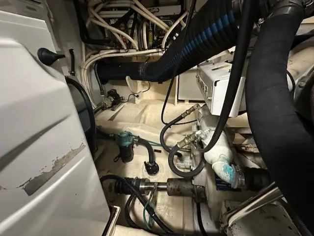 Slide: The Image of Engine room of a 2004 Sabre 42 Express Hardtop with visible hoses and machinery. - 61
