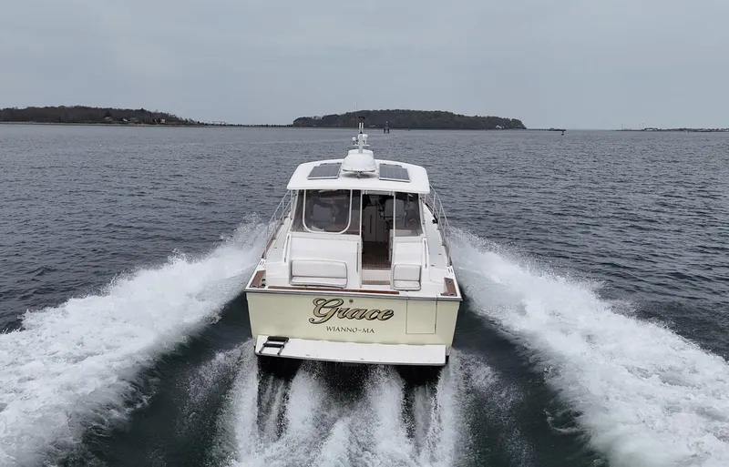 Slide: The Image of 2004 Sabre 42 Express Hardtop cruising on open water, rear view. - 7