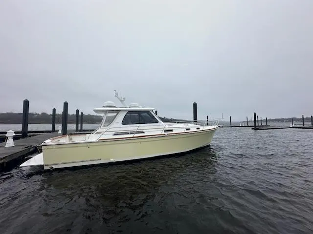 Slide: The Image of 2004 Sabre 42 Express Hardtop boat docked on a cloudy day. - 9