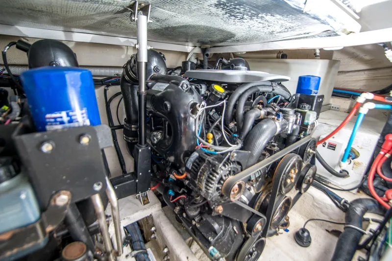 Slide: The Image of Engine room of a 2012 Rinker 310 Express Cruiser, showcasing detailed mechanical components. - 21