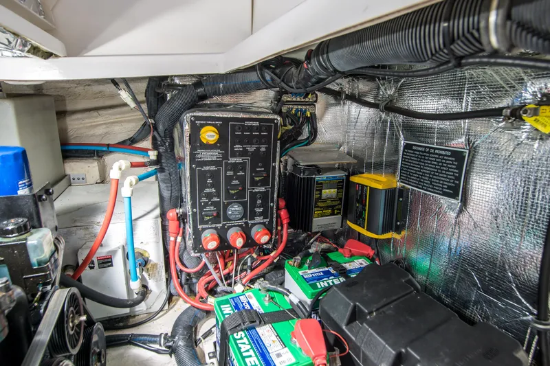 Slide: The Image of Engine compartment of a 2012 Rinker 310 Express Cruiser with electrical components and batteries. - 23
