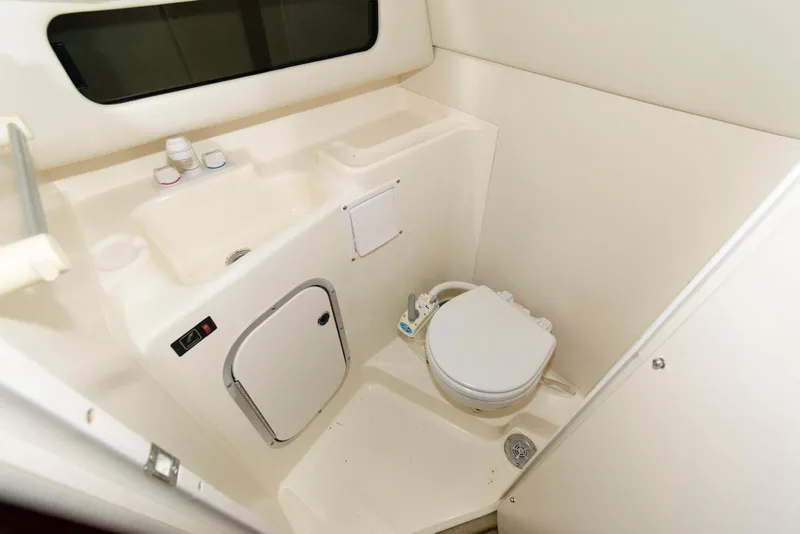 Slide: The Image of 2004 Bayliner 289 Classic boat bathroom with sink and toilet. - 12