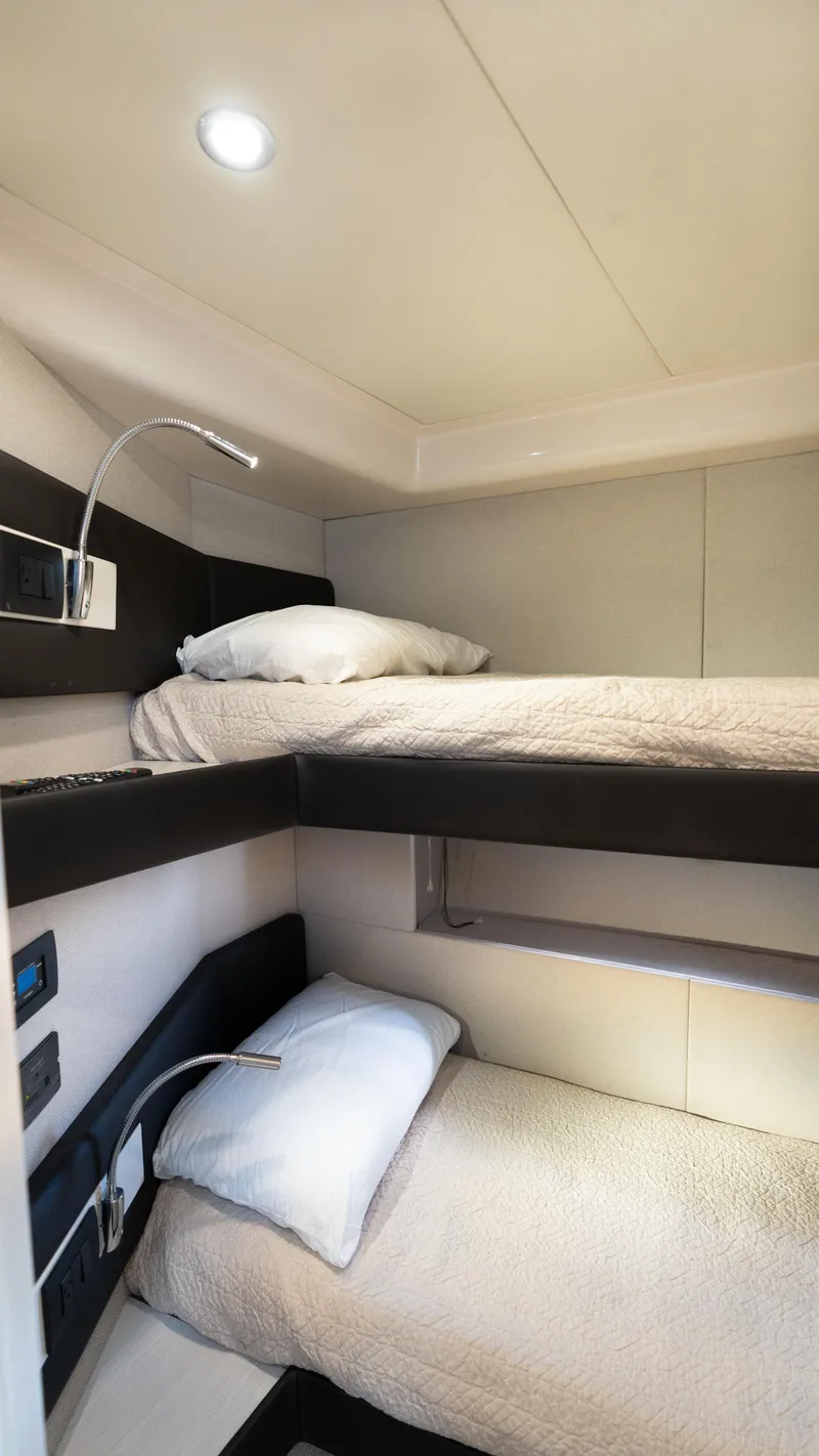 Slide: The Image of 2020 Azimut 50 Flybridge yacht cabin with modern bunk beds and sleek design. - 21