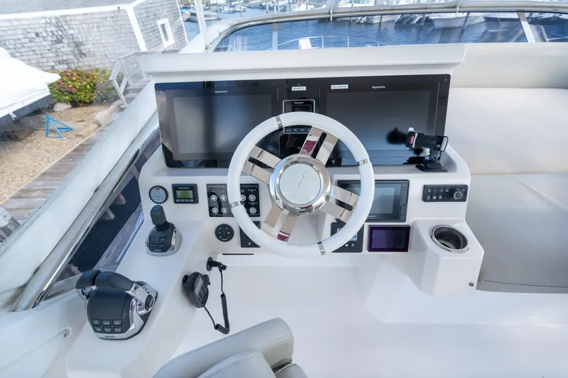 Slide: The Image of Cockpit of 2020 Azimut 50 Flybridge yacht with modern navigation equipment and steering wheel. - 30