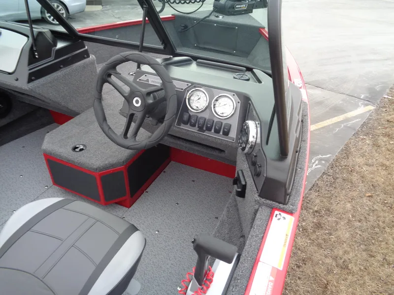 Slide: The Image of 2025 Lund 1775 Adventure Sport boat interior with steering wheel and dashboard controls. - 11