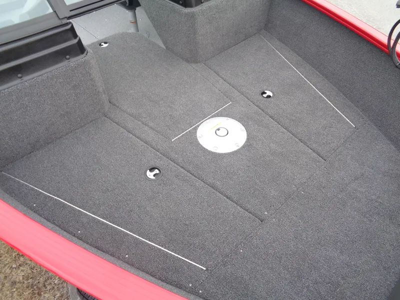 Slide: The Image of 2025 Lund 1775 Adventure Sport boat interior with gray carpet and red trim. - 4