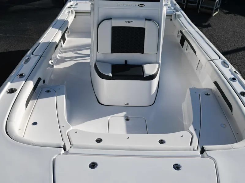 Slide: The Image of 2025 Tidewater 2500CB boat interior with sleek white seating and spacious deck design. - 12