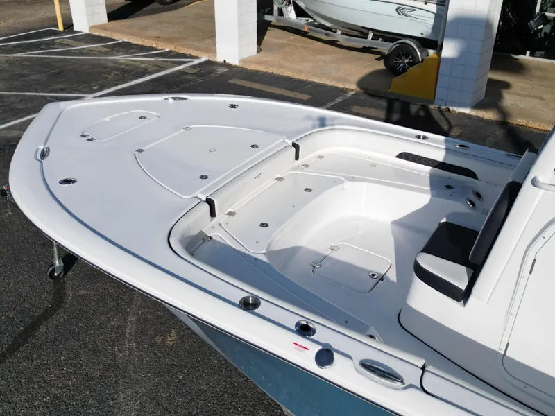 Slide: The Image of 2025 Tidewater 2500CB boat deck, featuring spacious seating and storage compartments. - 15