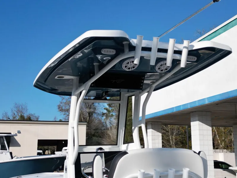 Slide: The Image of Tidewater 2500CB 2025 boat with T-top and rod holders under clear blue sky. - 20