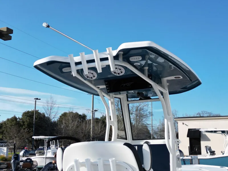 Slide: The Image of Tidewater 2500CB 2025 boat with T-top and rod holders under clear blue sky. - 21