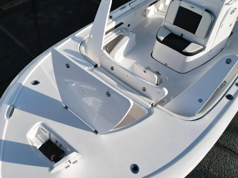 Slide: The Image of 2025 Tidewater 2500CB boat interior with open storage compartments and seating. - 25
