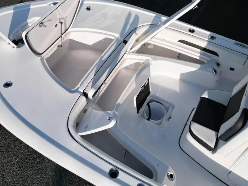 Slide: The Image of 2025 Tidewater 2500CB boat interior with open storage compartments and seating. - 26