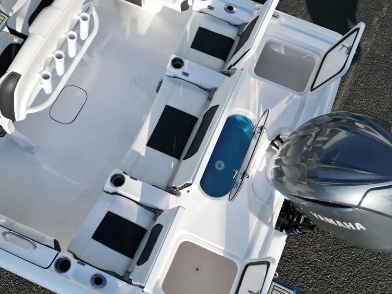 Slide: The Image of 2025 Tidewater 2500CB boat interior with seating, storage, and Yamaha engine. - 28