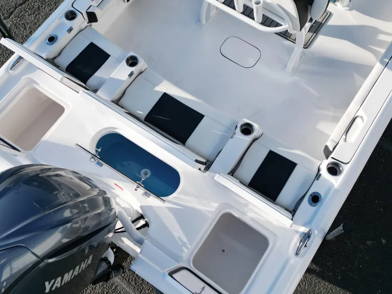 Slide: The Image of 2025 Tidewater 2500CB boat interior with Yamaha engine, featuring seating and storage compartments. - 29