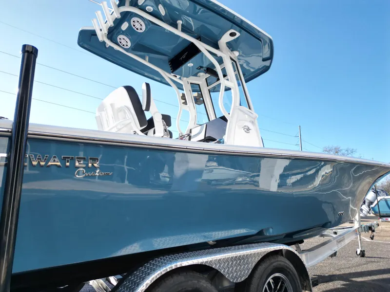 Slide: The Image of 2025 Tidewater 2500CB boat with sleek blue design on a trailer. - 7