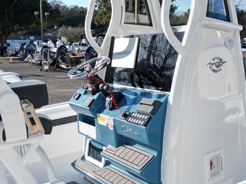 Slide: The Image of 2025 Tidewater 2500CB boat console with steering wheel and Garmin navigation system. - 8