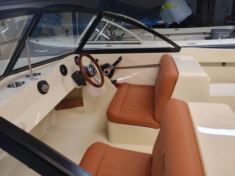 Slide: The Image of 2023 Rossiter Runabout 17 interior with tan seats and classic steering wheel. - 4