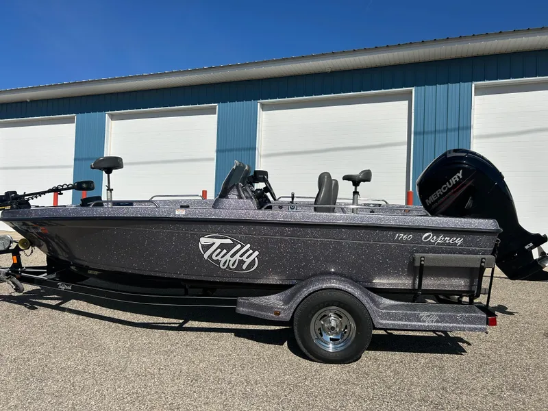 Slide: The Image of 2014 Tuffy 1760 Osprey fishing boat with Mercury engine, parked outdoors. - 0