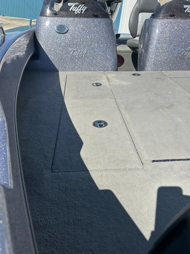 Slide: The Image of 2014 Tuffy 1760 Osprey boat interior with storage compartments and seating. - 11