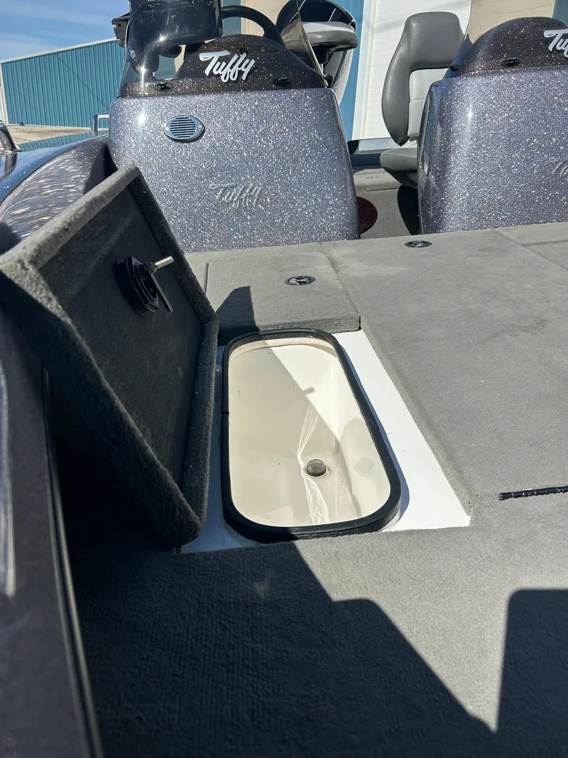 Slide: The Image of 2014 Tuffy 1760 Osprey boat interior with open storage compartment. - 12