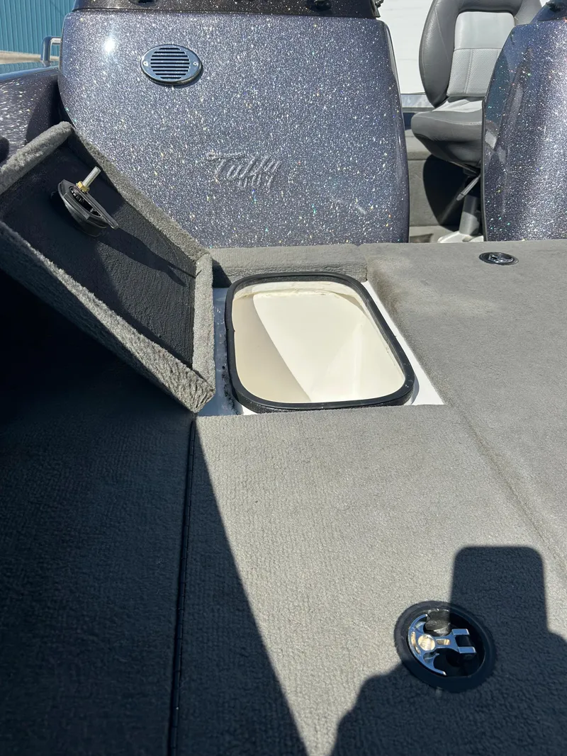 Slide: The Image of 2014 Tuffy 1760 Osprey boat interior with storage compartment open. - 13