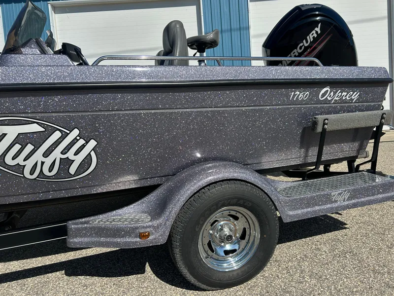 Slide: The Image of 2014 Tuffy 1760 Osprey boat with Mercury engine, parked on a trailer. - 19