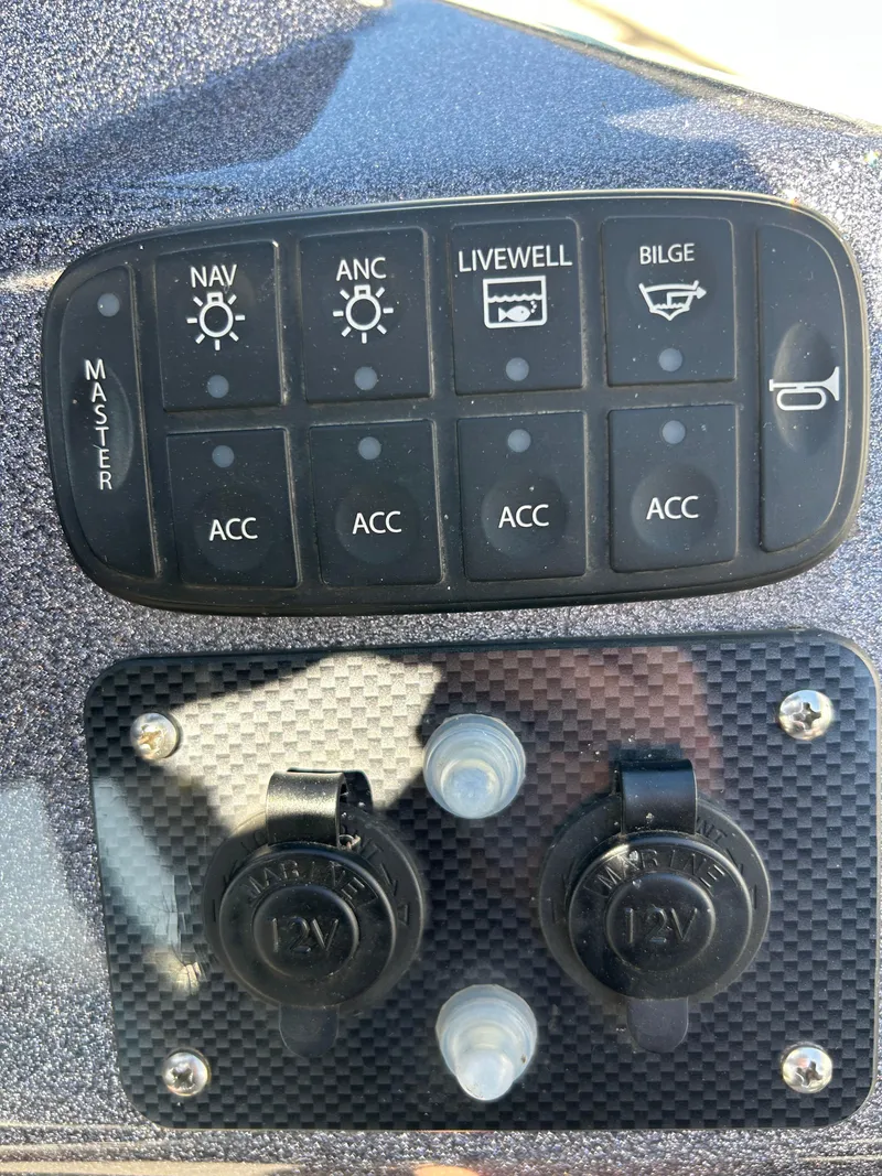 Slide: The Image of Control panel of a 2014 Tuffy 1760 Osprey boat with navigation and accessory switches. - 25