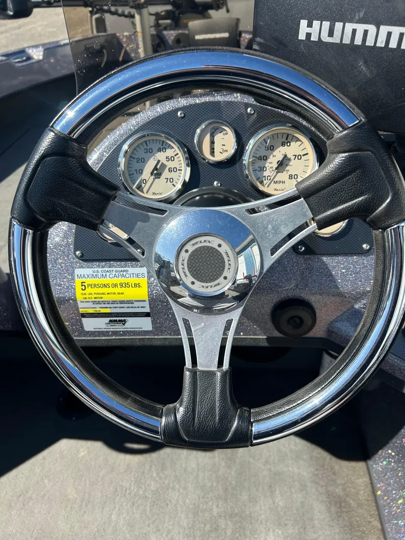Slide: The Image of Steering wheel and dashboard of 2014 Tuffy 1760 Osprey boat with gauges. - 26