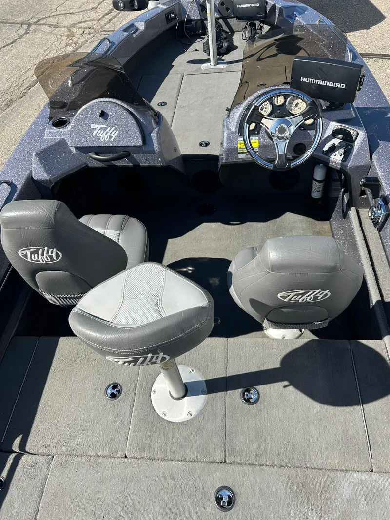 Slide: The Image of 2014 Tuffy 1760 Osprey boat interior with steering console and seating. - 29
