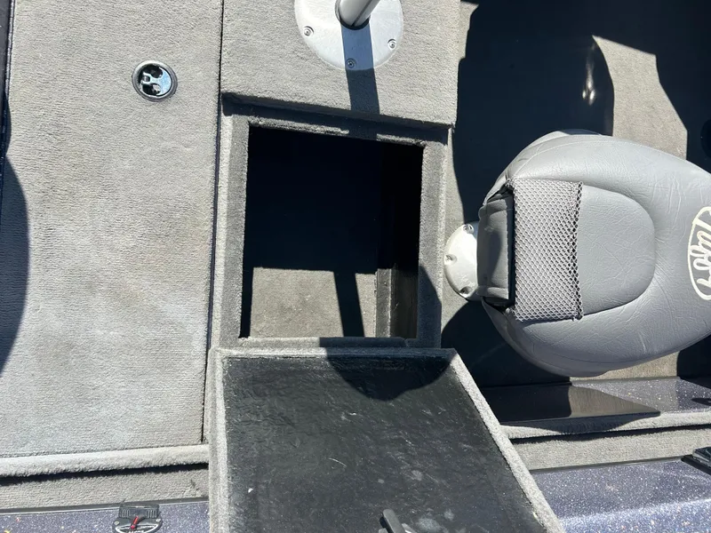 Slide: The Image of 2014 Tuffy 1760 Osprey boat interior with open storage compartment and seat. - 30