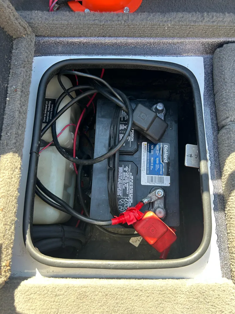 Slide: The Image of Battery compartment of a 2014 Tuffy 1760 Osprey boat, showing wiring and connections. - 32