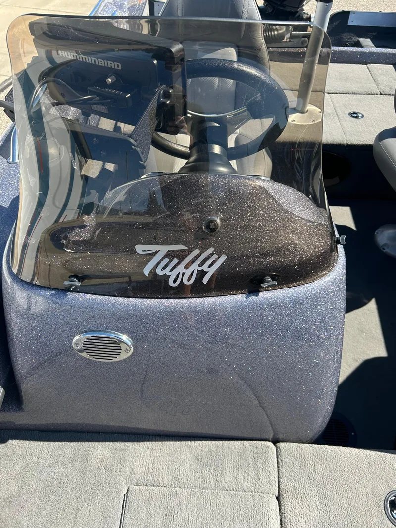 Slide: The Image of 2014 Tuffy 1760 Osprey boat console with steering wheel and windshield. - 43