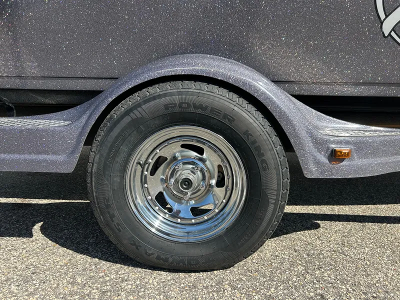 Slide: The Image of 2014 Tuffy 1760 Osprey trailer wheel with chrome rim and black tire. - 8