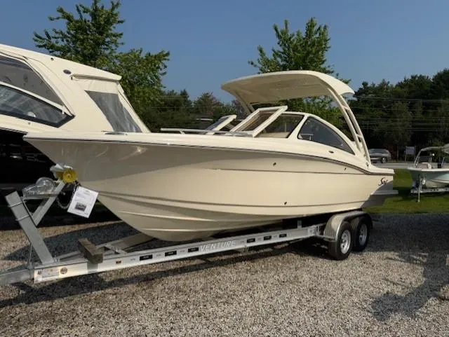 The Image of 2025 Scout 240 Dorado boat on trailer, parked outdoors, showcasing sleek design. - 0