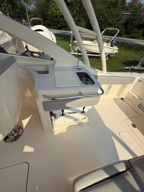 Slide: The Image of 2025 Scout 240 Dorado boat interior with sink and seating area. - 10