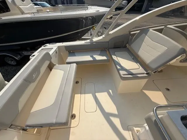 Slide: The Image of 2025 Scout 240 Dorado boat interior with beige seating and spacious layout. - 8
