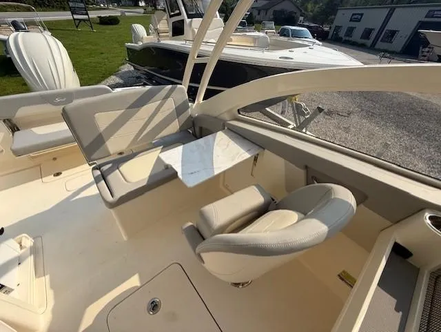 Slide: The Image of 2025 Scout 240 Dorado boat interior with seating and table, showcasing luxury design features. - 9