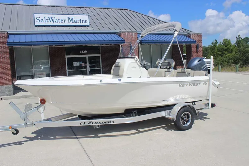 Slide: The Image of 2025 Key West 189 FS boat on trailer outside SaltWater Marine dealership. - 10