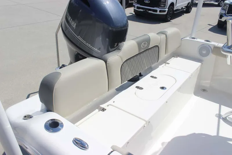 Slide: The Image of 2025 Key West 189 FS boat interior with Yamaha engine, featuring cushioned seating and storage. - 19