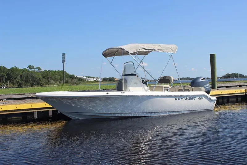 Slide: The Image of 2025 Key West 189 FS boat docked on calm water under clear blue sky. - 3