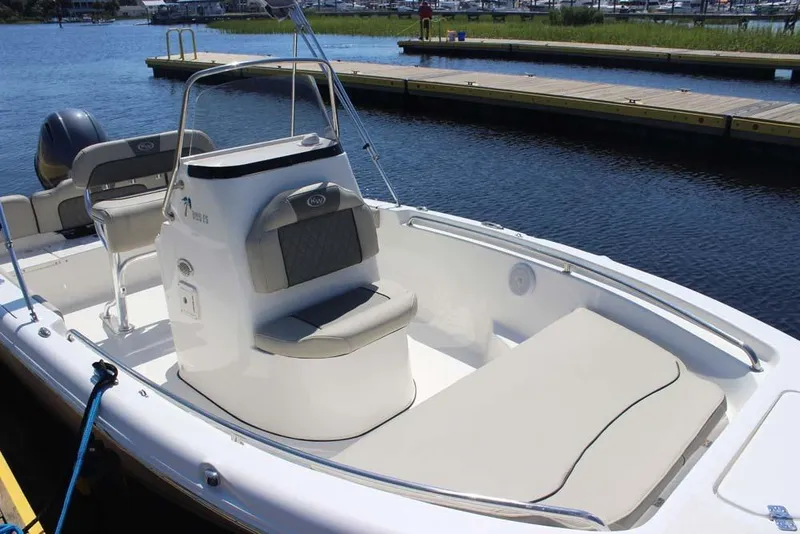 Slide: The Image of 2025 Key West 189 FS boat docked by the water, featuring comfortable seating and sleek design. - 5