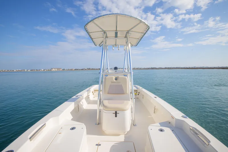Slide: The Image of Pathfinder 2005 TRS boat on calm water, featuring a center console and T-top, 2022 model. - 13