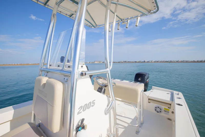 Slide: The Image of Pathfinder 2005 TRS boat on water, showcasing helm and seating, 2022 model. - 14