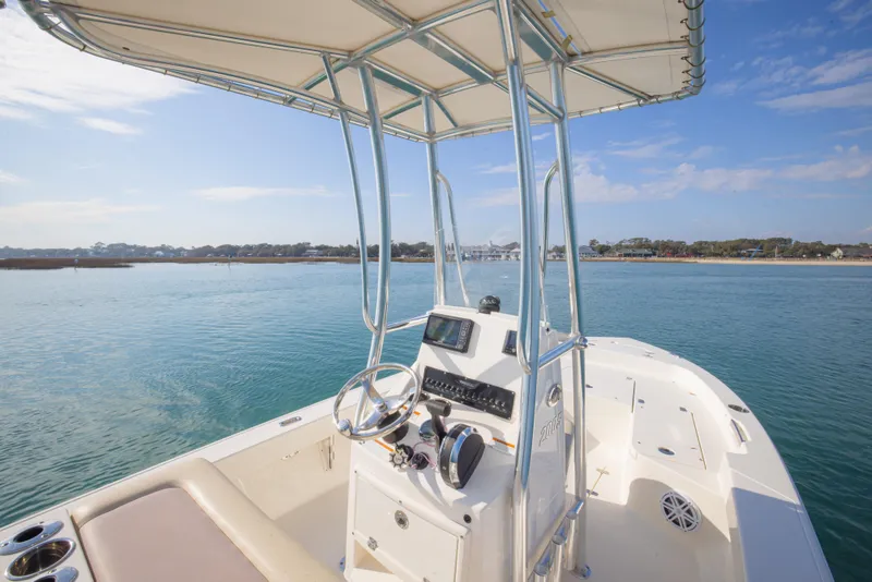 Slide: The Image of Pathfinder 2005 TRS boat on calm water, featuring a sleek console and canopy. - 16