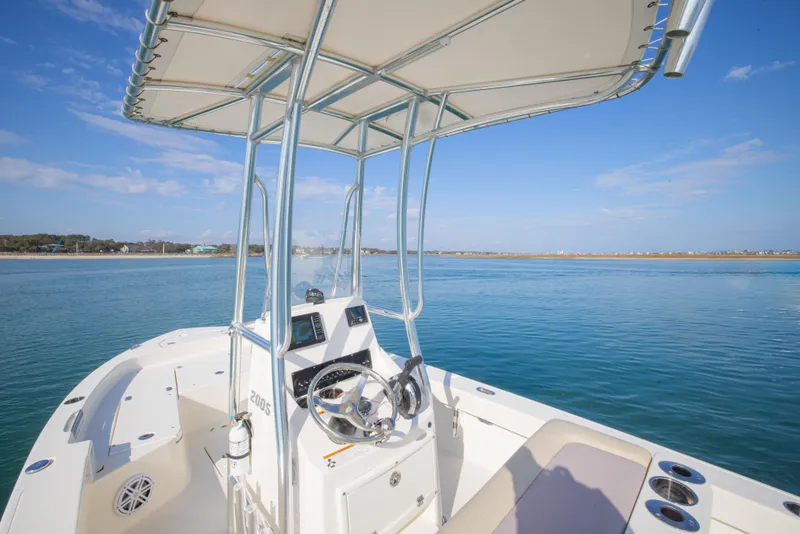 Slide: The Image of Pathfinder 2005 TRS boat on calm water, featuring a sleek console and canopy. - 18